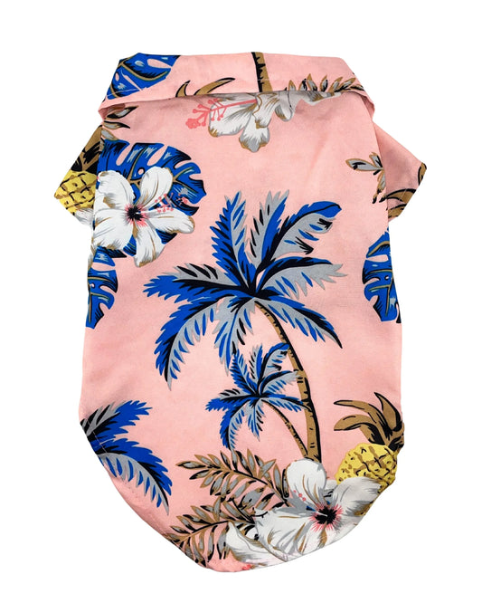 Camisa hawaiana para perros en color rosa con estampado de palmeras y flores tropicales.