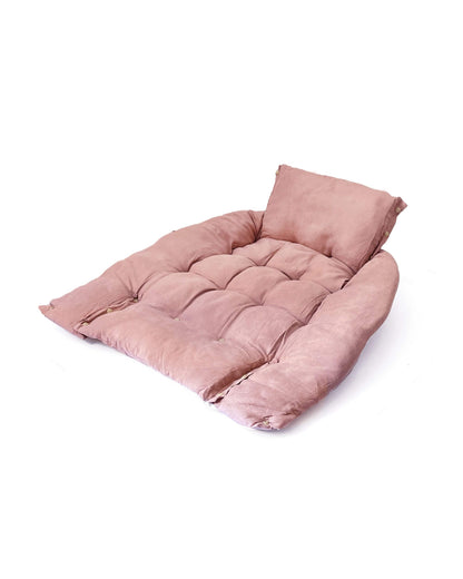 Cama transformable rosa para perro, parcialmente doblada.