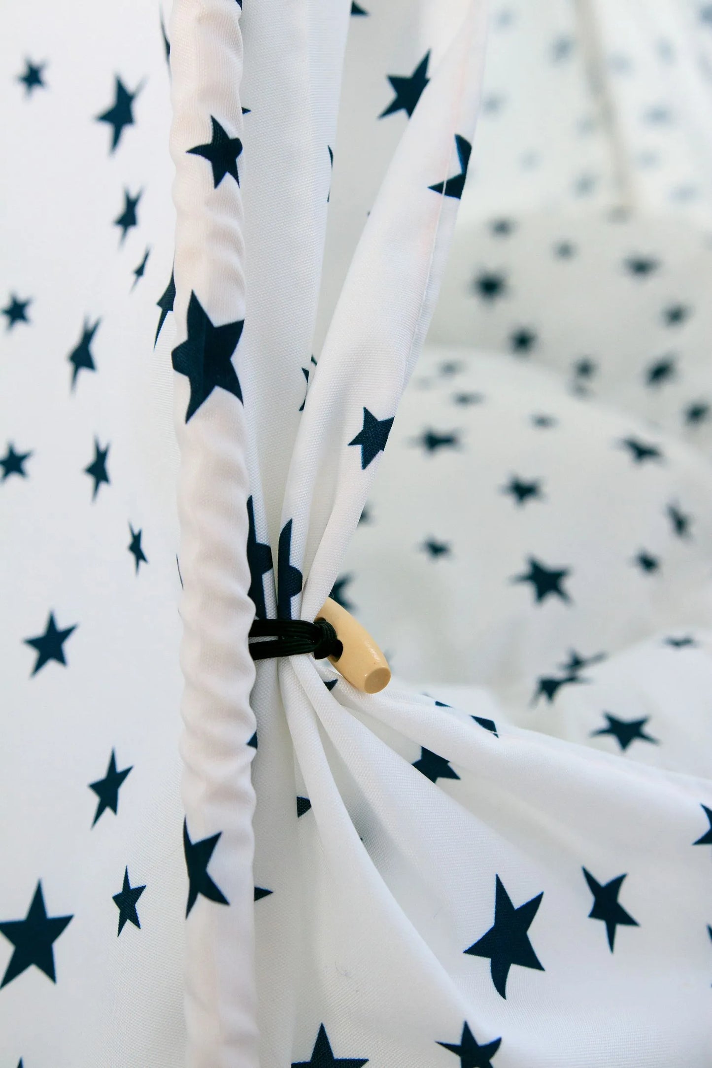 Detalle de las cortinas de la carpa con estampado de estrellas azul.